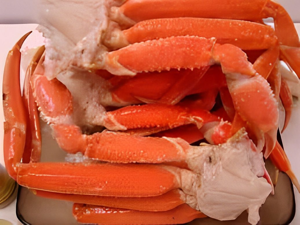 Cooked crab legs stacked on a plate.