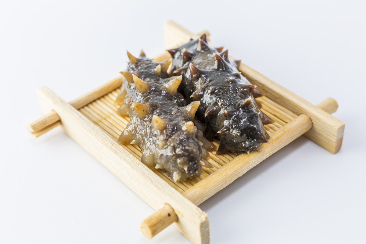 Sea cucumbers on a wooden tray.