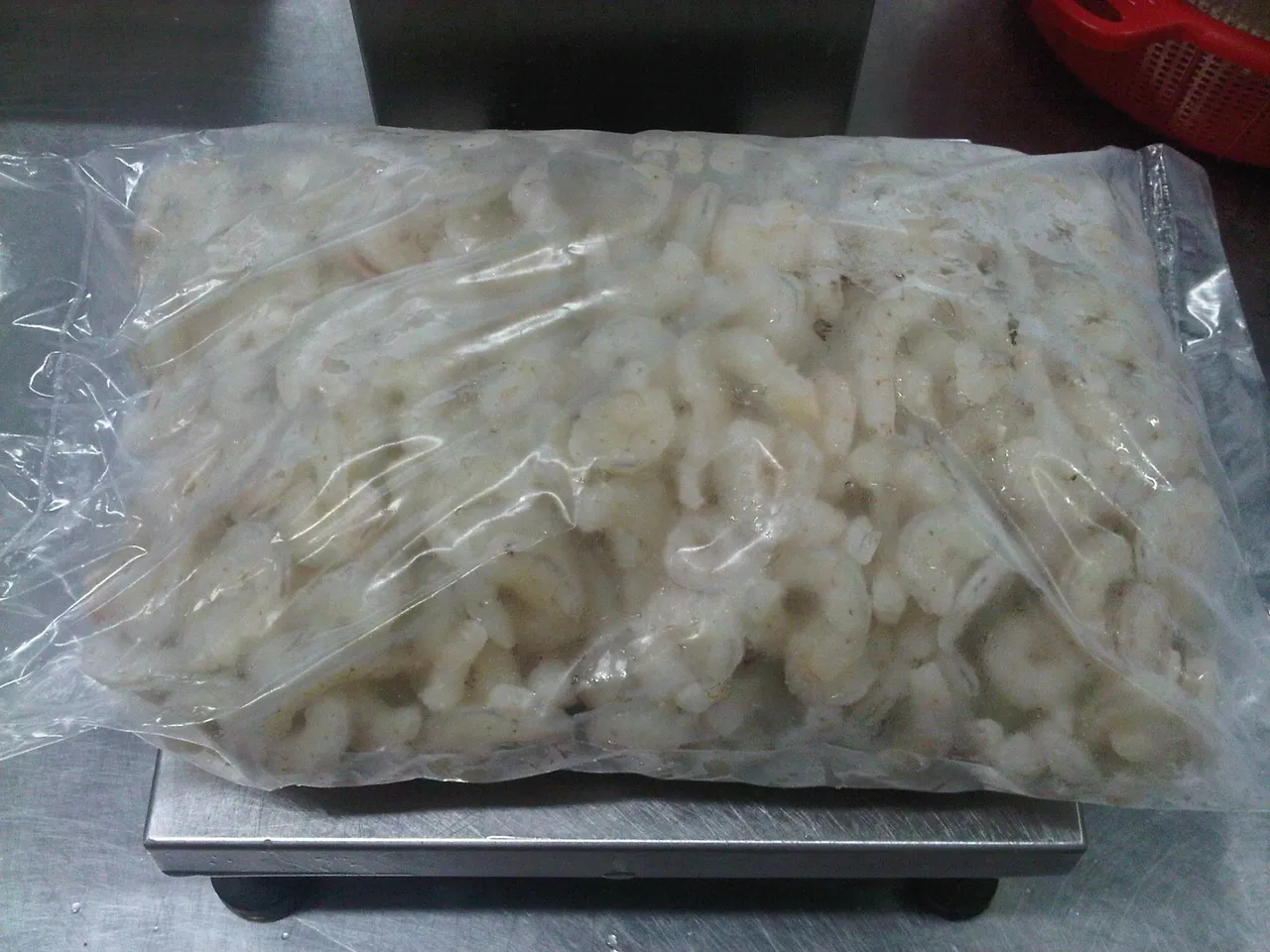 Bag of frozen shrimp on a scale.